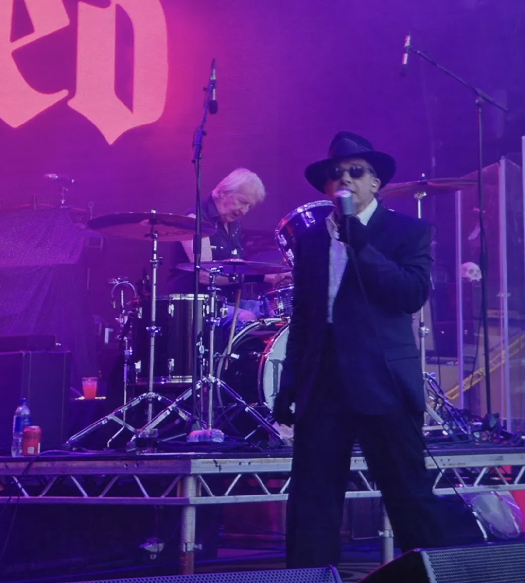 Dave Vanian of The Damned at the microphone, drummer behind him